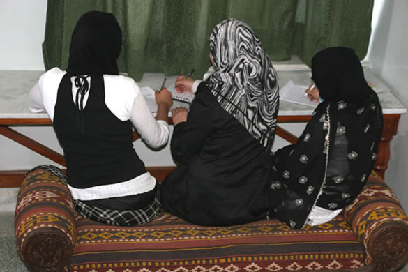 Photo of three women writing
